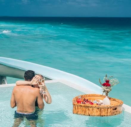 Valetines Day offer at Siyam World Maldives, A couple enjoying floating breakfast in the pool