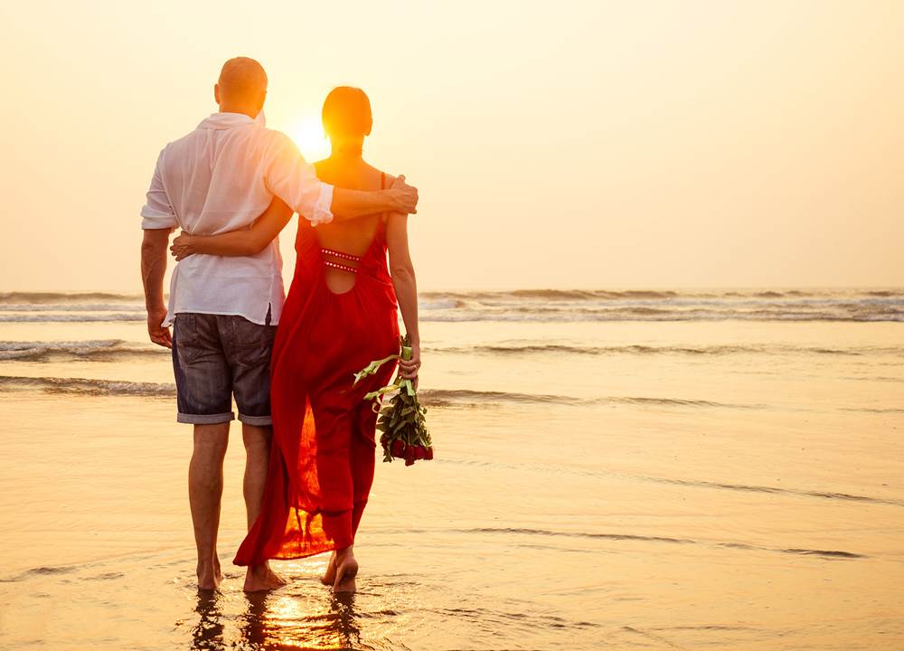 Couples walking by the beach