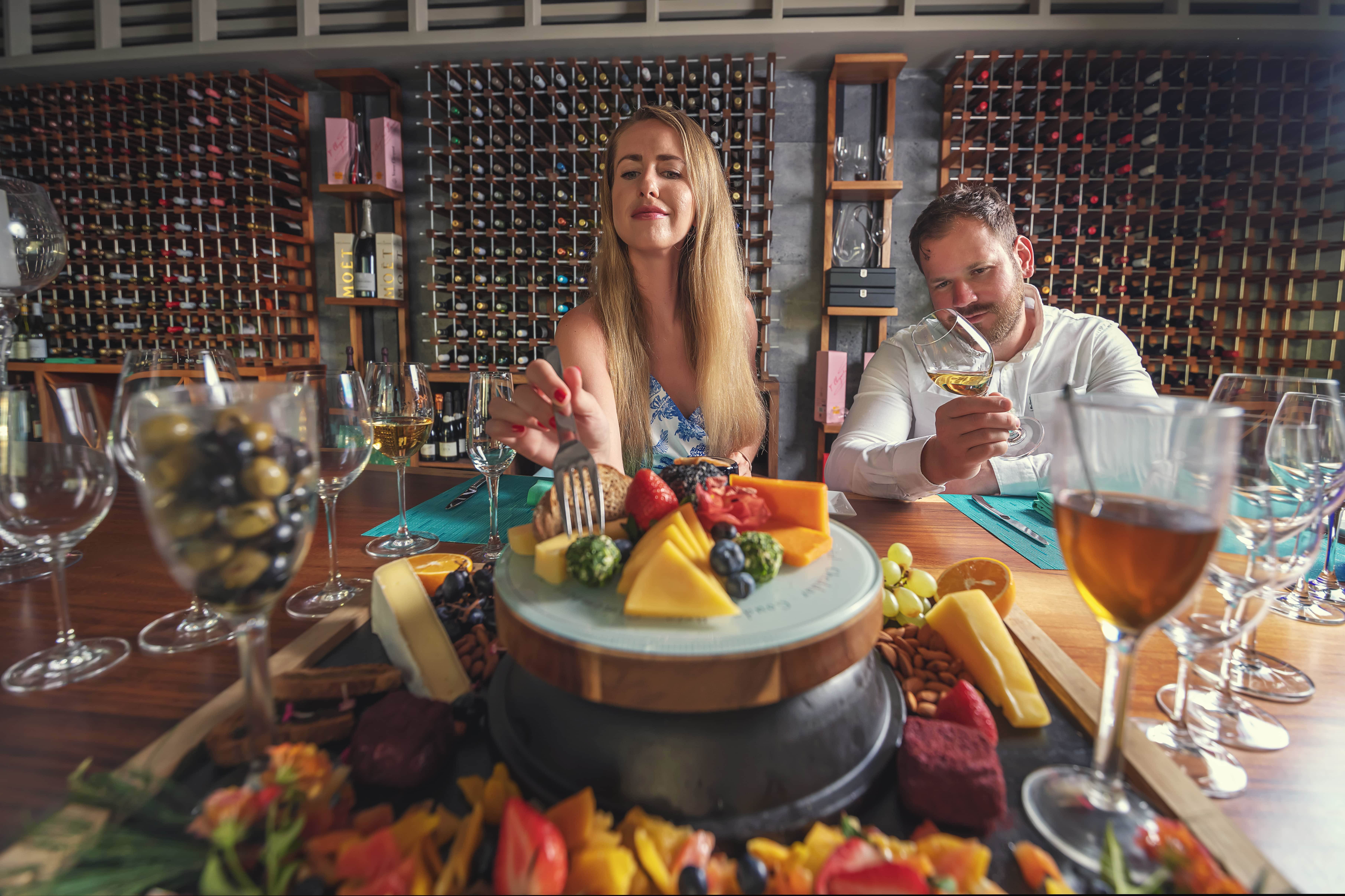Couple eating cheese platter in Roma Restaurant at Sun Siyam Iru Veli Maldives